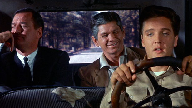 Willy (Gig Young) and Lew (Charles Bronson) listen as Walter (Elvis Presley) sings "Riding The Rainbow" while driving a Model T Ford in 1962's KID GALAHAD (United Artists)