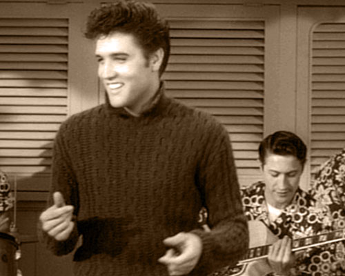 Vince Everett (Elvis Presley) sings "Baby, I Don't Care" at a pool party as a guitarist (Scotty Moore) plays along in the background in 1957's JAILHOUSE ROCK (MGM)